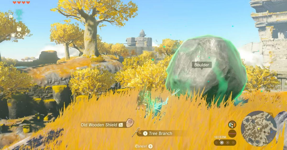 Link usando l'abilità Fusione per combinare un masso e un bastone in Tears of the Kingdom.