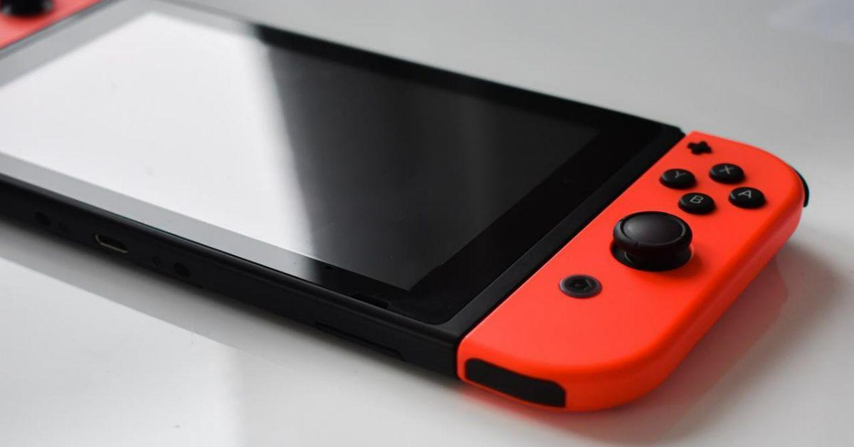 En Nintendo Switch-konsol på en hvid bordplade.