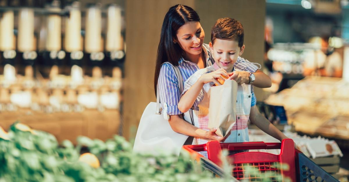 Madre e figlio che acquistano frutta al supermercato o al supermercato 